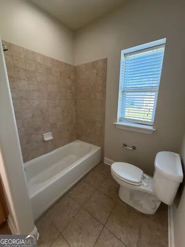 a bathroom with a toilet a sink and bathtub