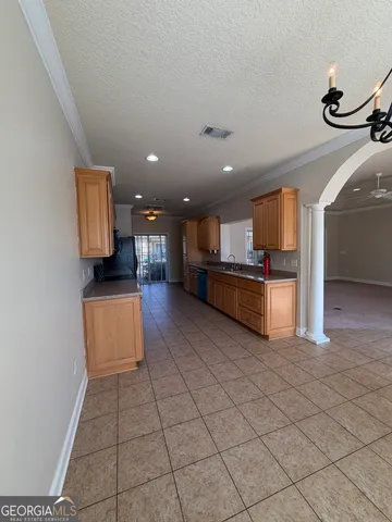 a kitchen with stainless steel appliances granite countertop a refrigerator and a stove