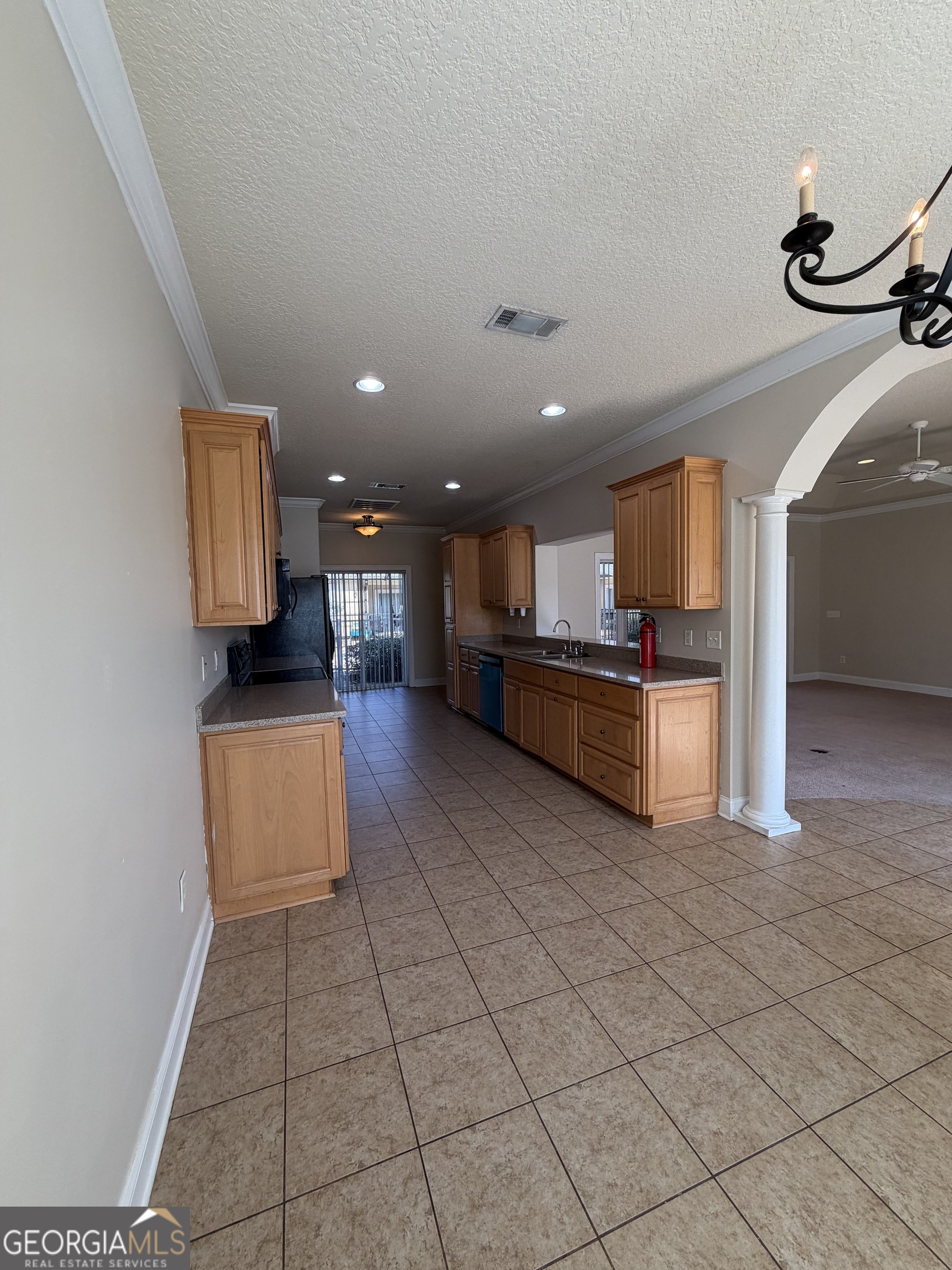 36 Coastal Walk St. Marys, GA 31558 - Photo 30 of 40 a kitchen with stainless steel appliances granite countertop a refrigerator and a stove