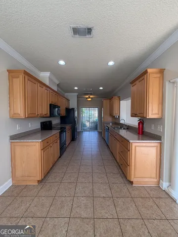 a large kitchen with stainless steel appliances lots of counter top space