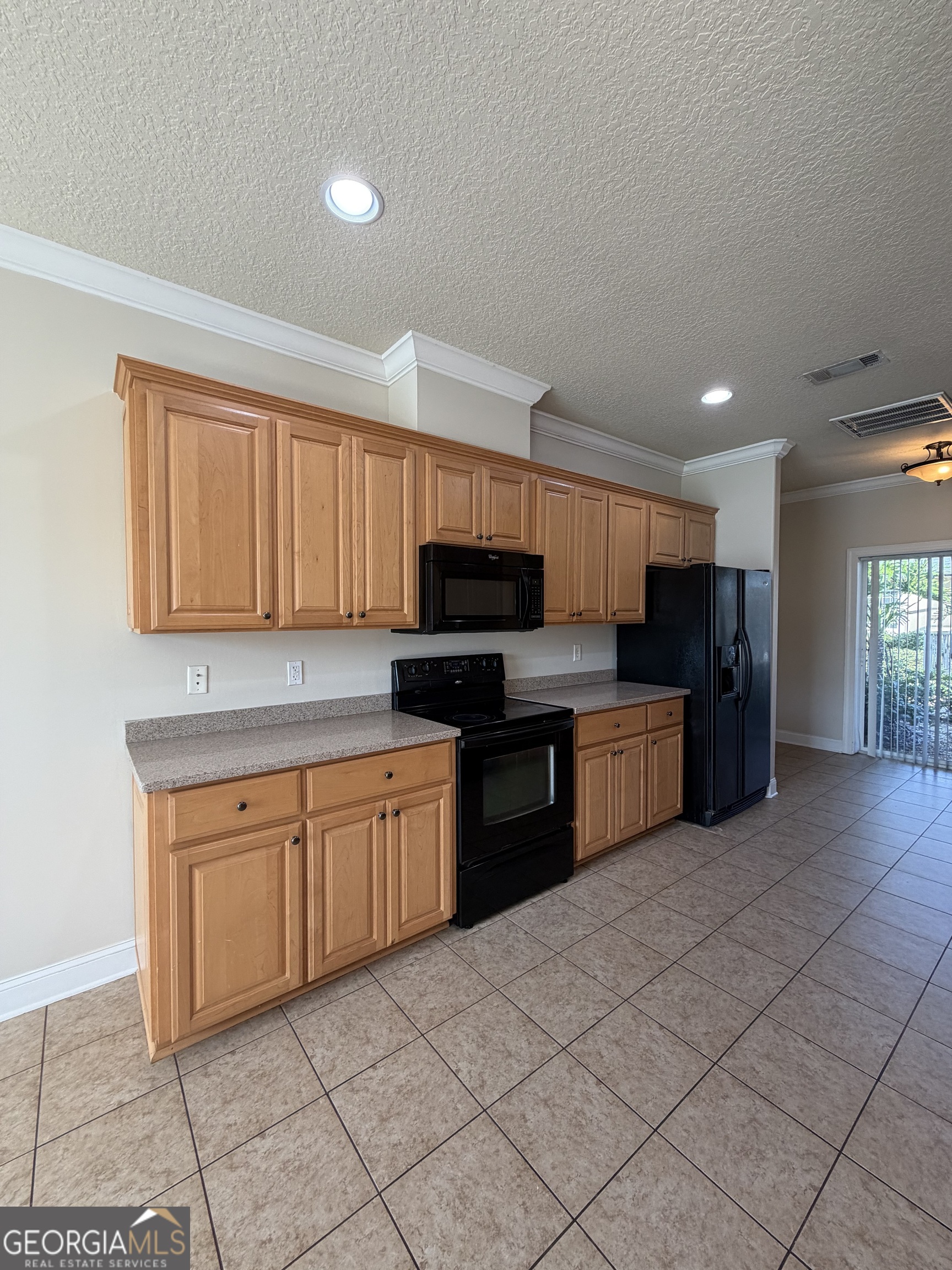 36 Coastal Walk St. Marys, GA 31558 - Photo 32 of 40 a kitchen with stainless steel appliances granite countertop a stove sink and cabinets