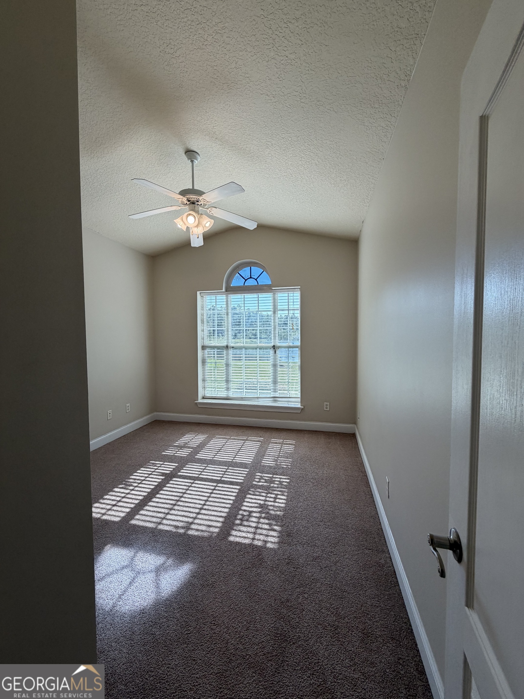36 Coastal Walk St. Marys, GA 31558 - Photo 9 of 40 an empty room with windows and fan