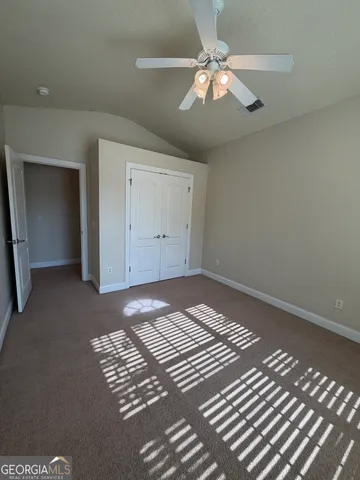 a view of a room with wooden floor and closet