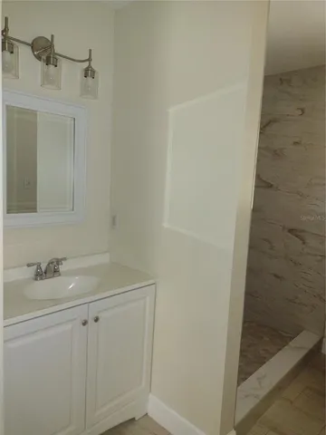 a bathroom with a sink and mirror