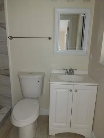 a white house that has a tree in front of it