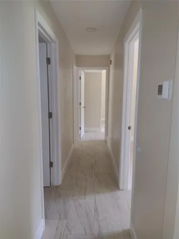 a view of a hallway to rooms