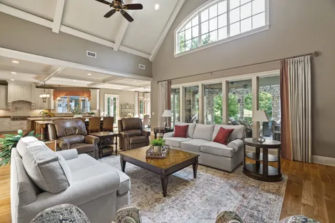 a large kitchen with stainless steel appliances granite countertop a lot of counter space and wooden floors