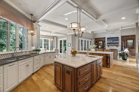 a bedroom with a bed and glass walk in closet