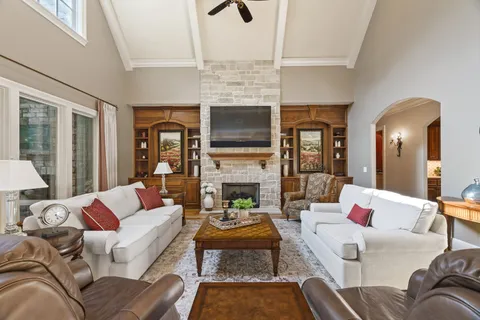 a living room with furniture fireplace and flat screen tv