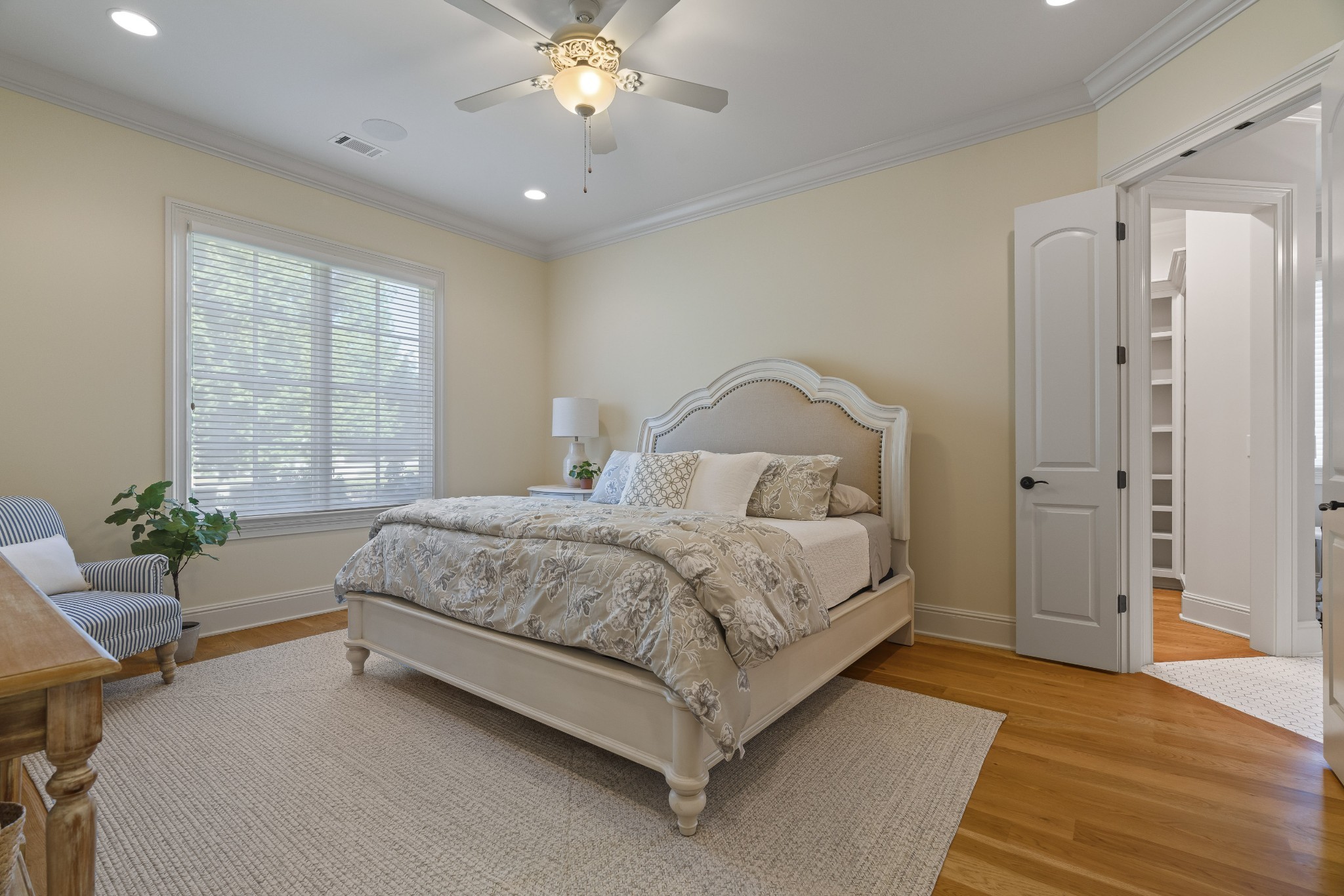 8127 Mountaintop Drive College Grove, TN 37046 - Photo 60 of 72 a spacious bedroom with a large bed and a chandelier