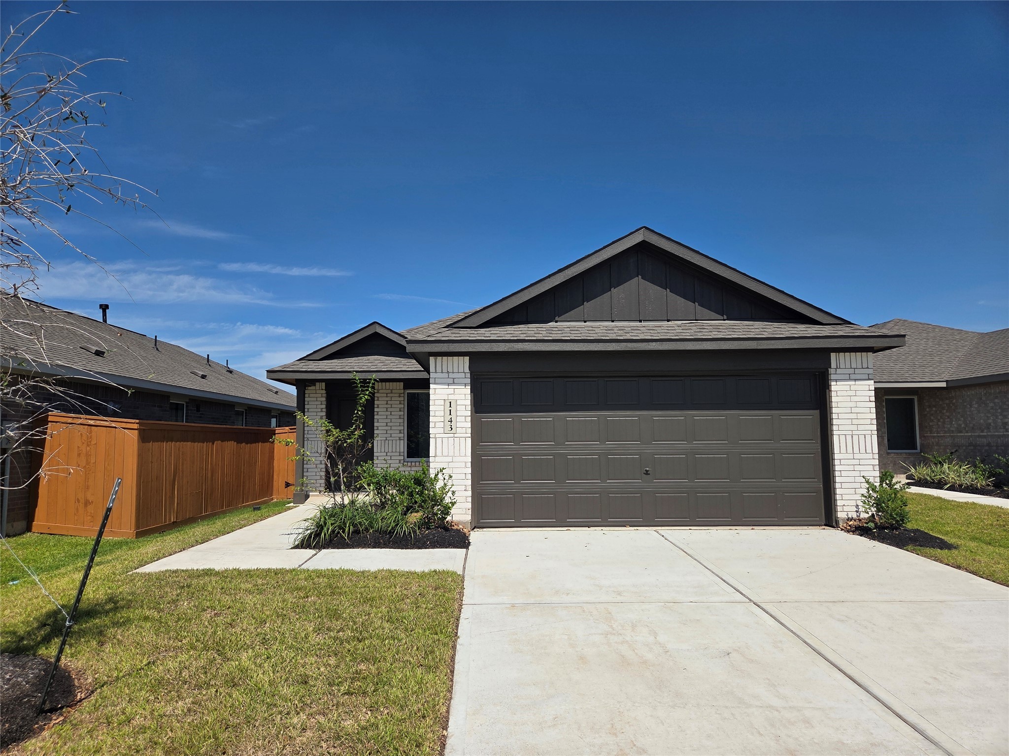 1143 Blue Stone Drive Beasley, TX 77417 - Photo 1 of 24 a front view of a house with a yard and garage
