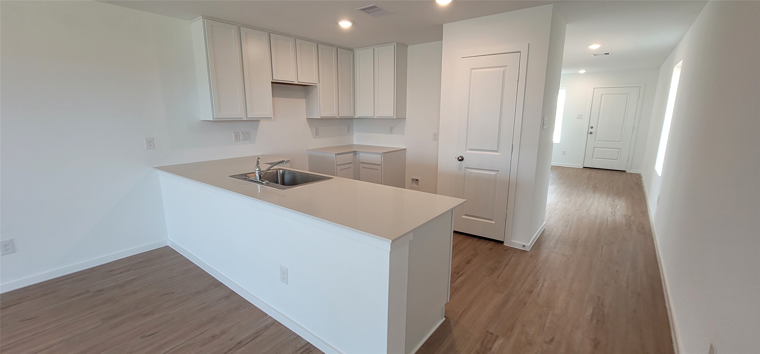 1143 Blue Stone Drive Beasley, TX 77417 - Photo 19 of 24 a kitchen with a sink a refrigerator and wooden floor