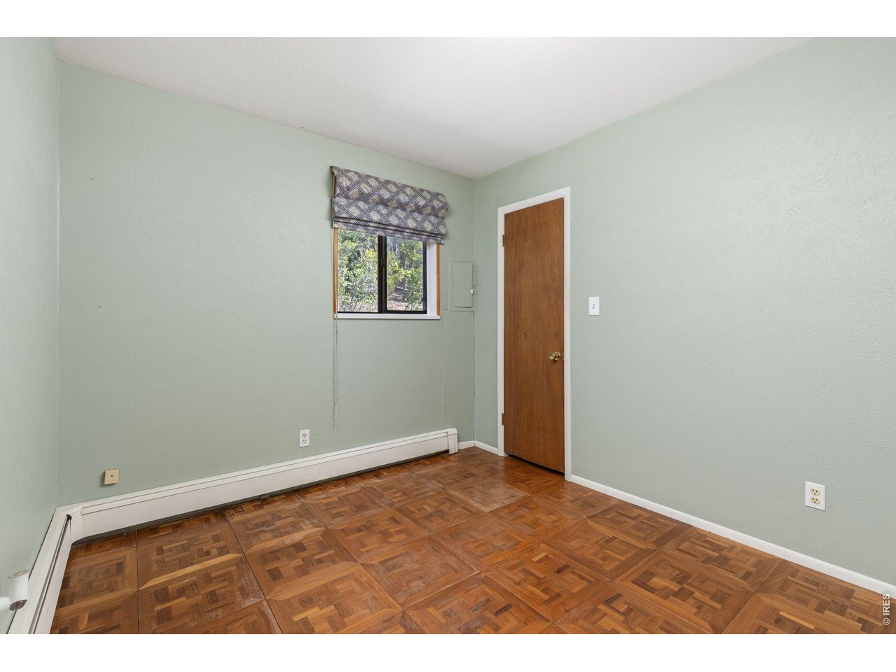 414 Upper Travis Gulch Road Black Hawk, CO 80422 - Photo 22 of 50 an empty room with wooden floor and windows