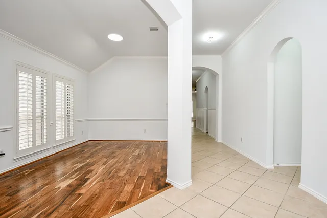 a view of empty room with wooden floor and fireplace