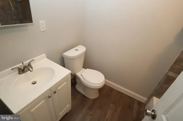 a white toilet sitting next to a white sink