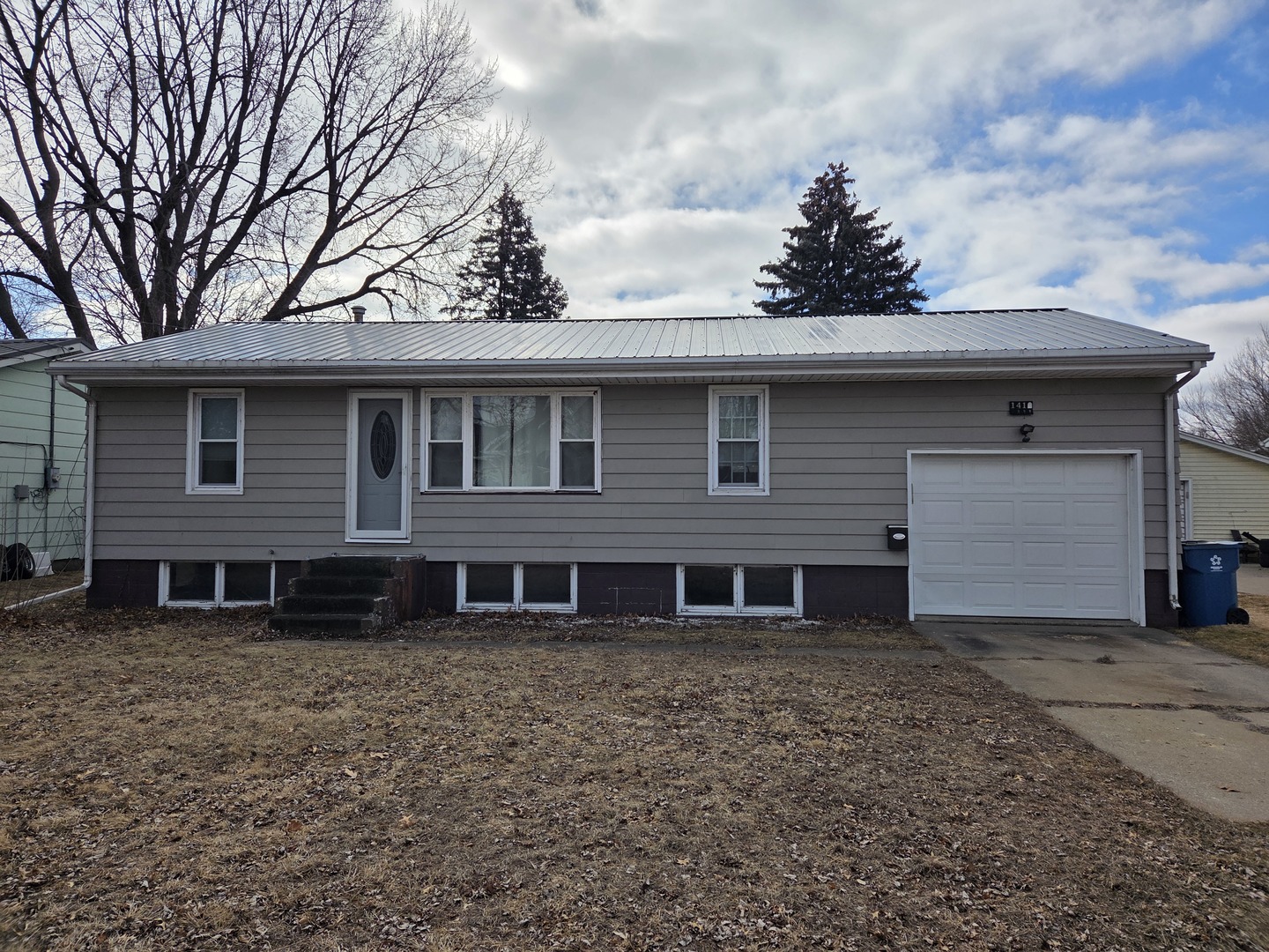 1419 5th Street Camanche, IA 52730 - Photo 1 of 14 a front view of a house with a garden