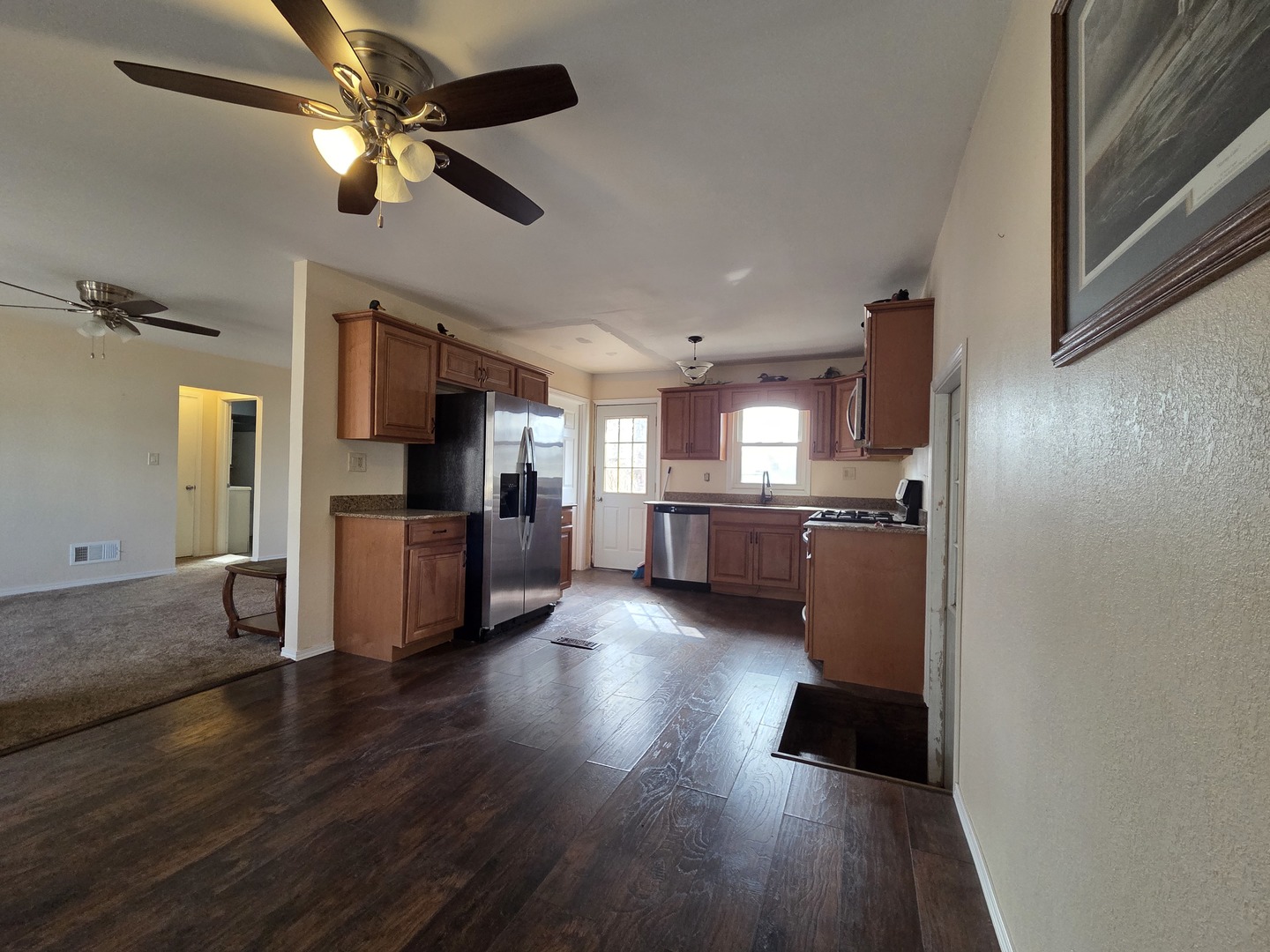 1419 5th Street Camanche, IA 52730 - Photo 6 of 14 a view of kitchen and empty room with wooden floor