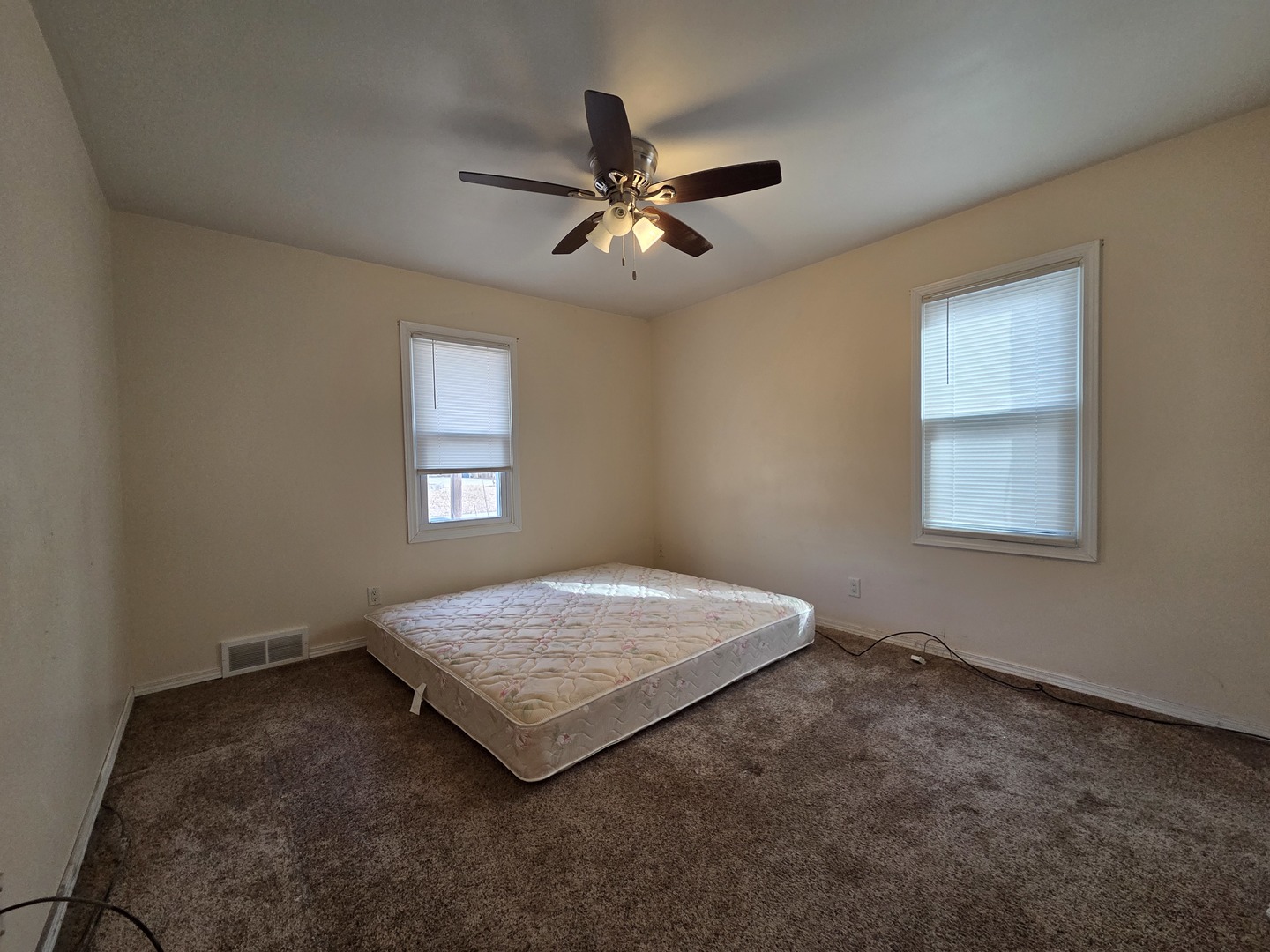1419 5th Street Camanche, IA 52730 - Photo 8 of 14 an empty room with a window and a ceiling fan