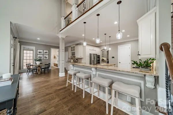 a large kitchen with a table and chairs