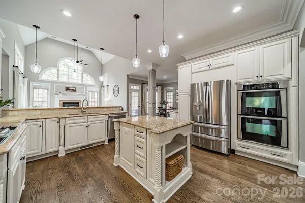 a kitchen with stainless steel appliances granite countertop a stove and a refrigerator