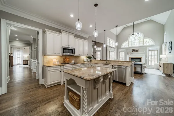 a kitchen with stainless steel appliances granite countertop a stove oven and a refrigerator