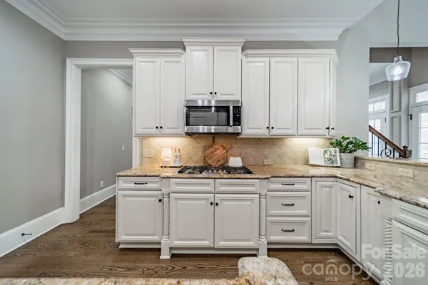 a kitchen with stainless steel appliances granite countertop a sink and cabinets