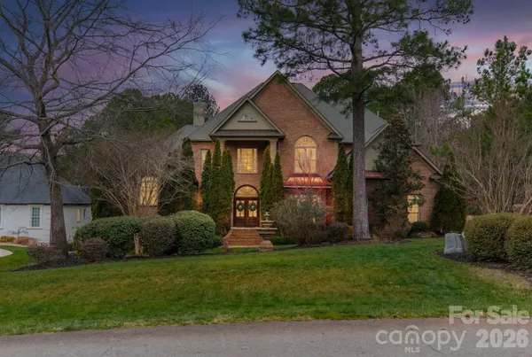 a front view of house with a garden