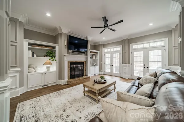 a living room with furniture a fireplace and a flat screen tv