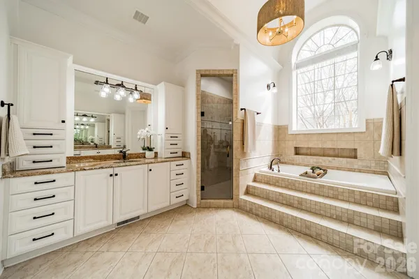 a spacious bathroom with a double vanity sink and a bathtub
