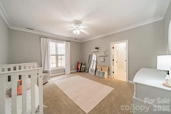 a spacious bedroom with a bed and a window