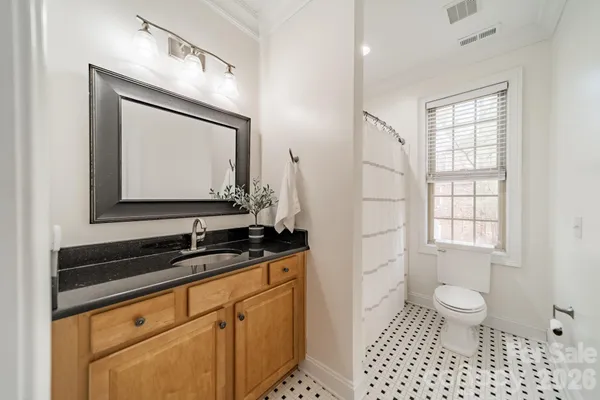 a bathroom with a sink a toilet and a mirror