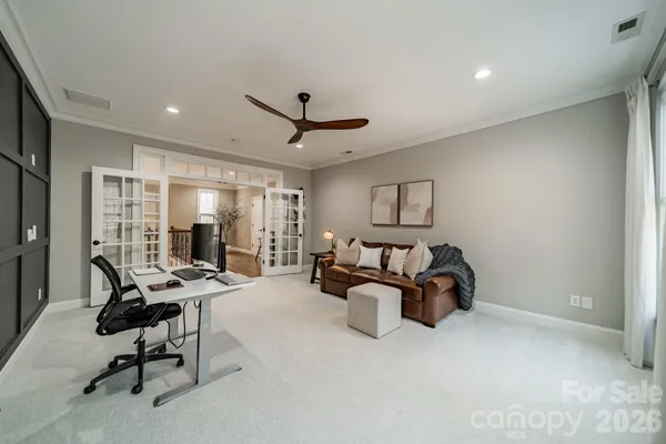 a view of a livingroom with workspace and a window