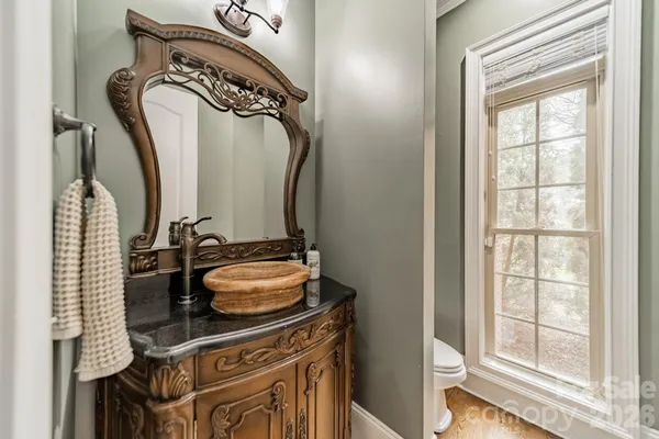 a bathroom with a granite countertop sink a vanity and a mirror