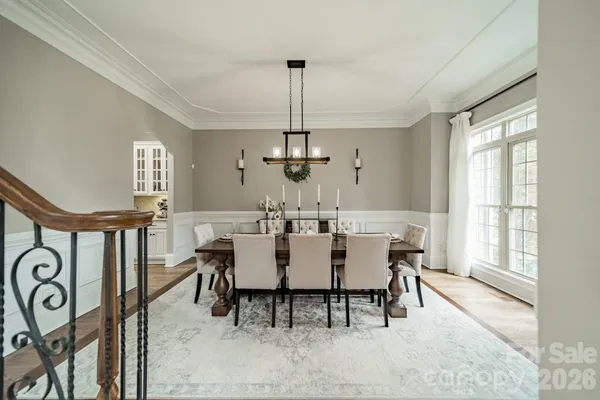 a view of a a dining room with furniture window and wooden floor