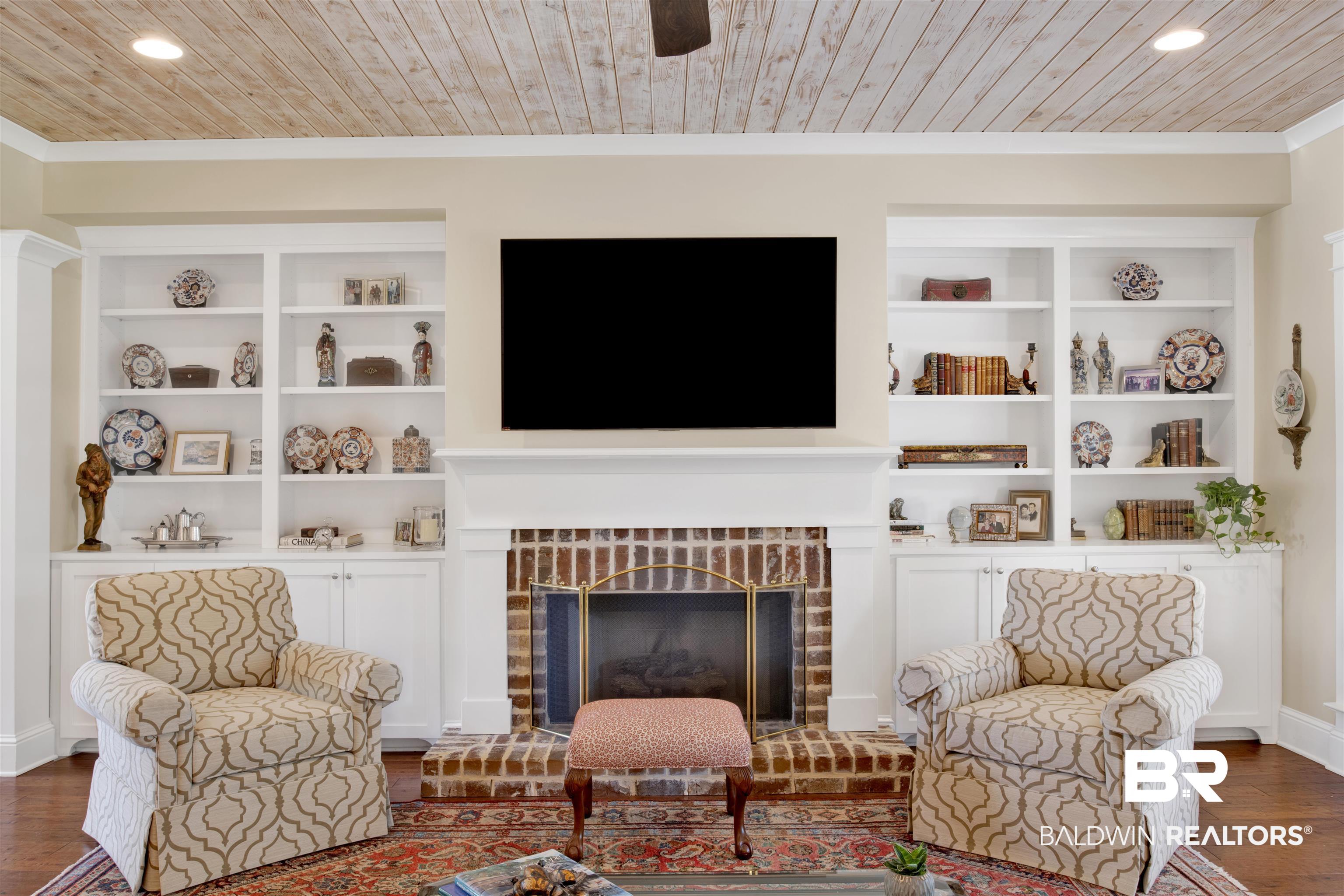 131 Sedgefield Avenue Fairhope, AL 36532 - Photo 12 of 50 Interior space with dark hardwood / wood-style floors, a brick fireplace, wood ceiling, and ornamental molding