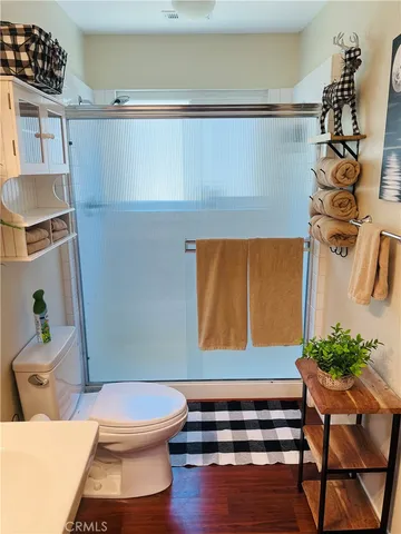 a bathroom with a toilet and a shower curtain