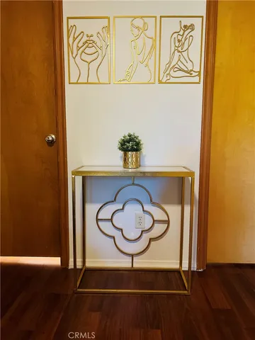 a table with a wooden floor and a potted plant