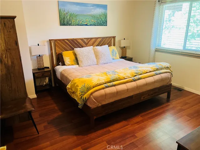 a bed sitting in a bedroom next to a window