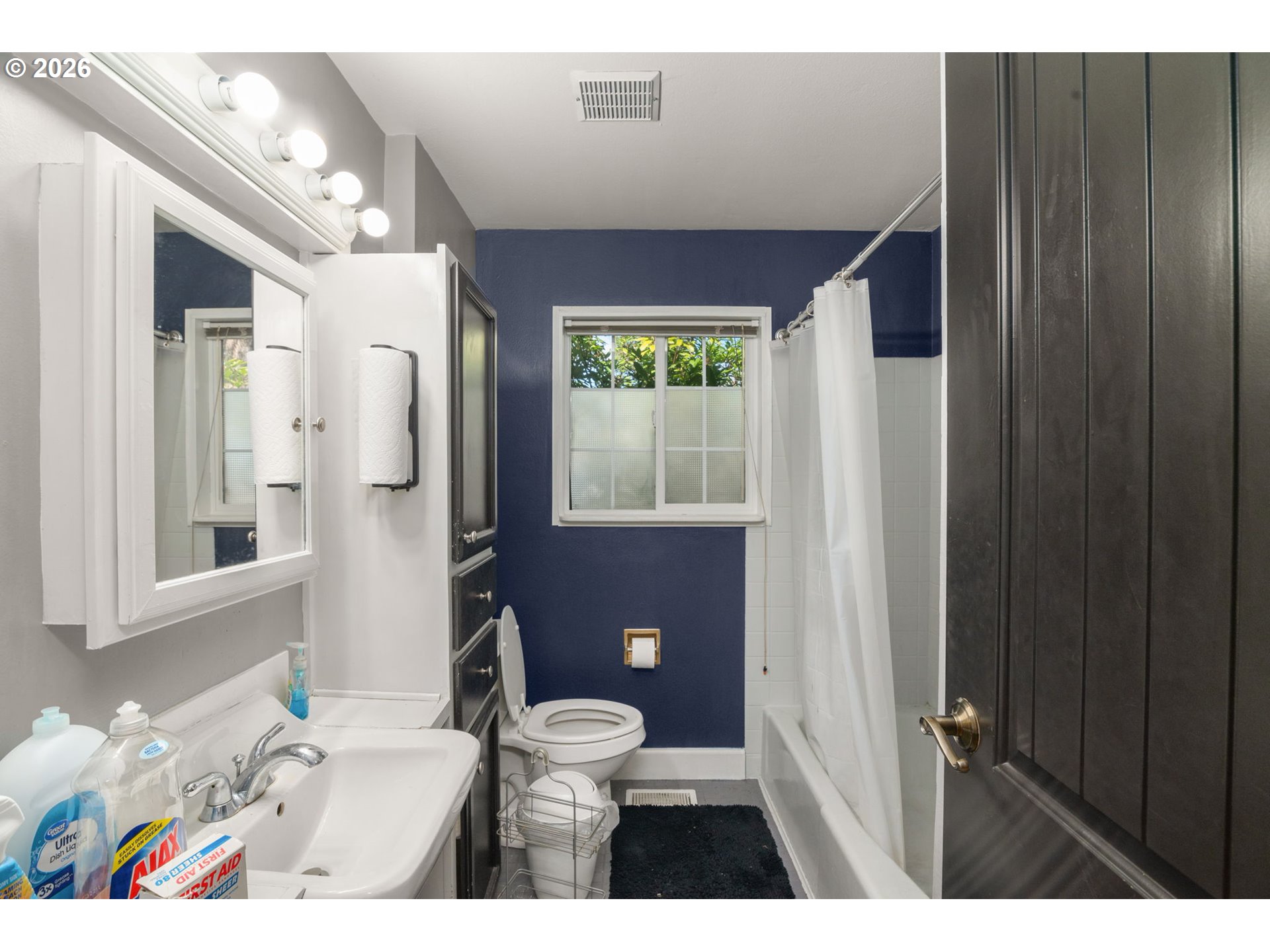 13670 Southwest 21st Street Beaverton, OR 97008 - Photo 13 of 26 a bathroom with a sink a toilet and shower curtain