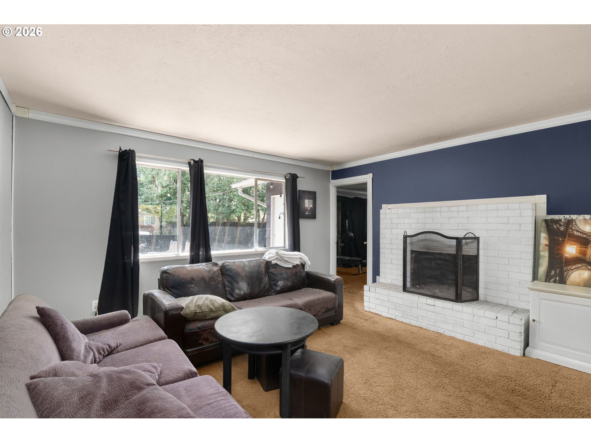 13670 Southwest 21st Street Beaverton, OR 97008 - Photo 8 of 26 a living room with furniture and a fireplace