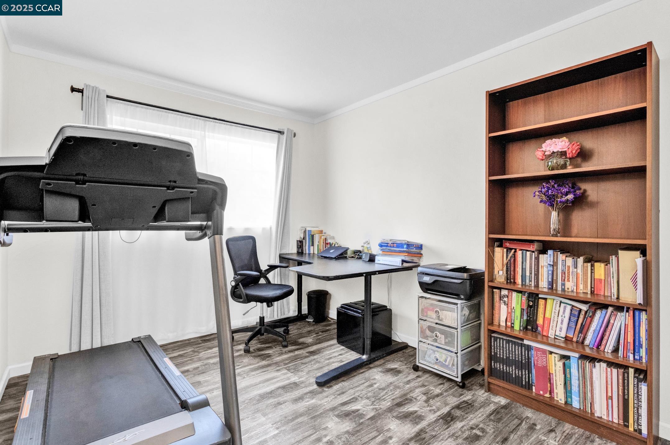 2919 Willow Road San Pablo, CA 94806 - Photo 1 of 1 a view of a workspace with furniture and a book shelf