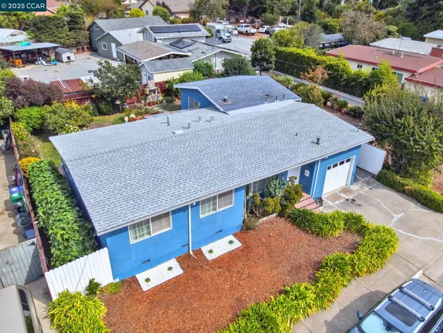an aerial view of a house with a yard patio and lake view
