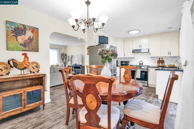 a view of a dining room with furniture wooden floor and chandelier