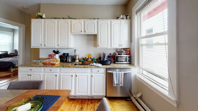 a kitchen with cabinets and window