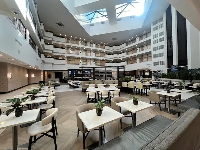 a view of a kitchen with lots of chairs and breakfast area