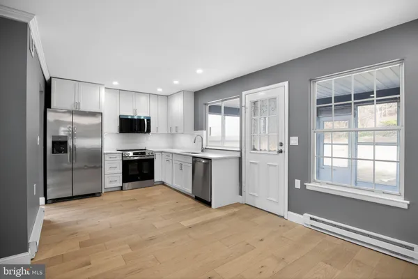 a kitchen with stainless steel appliances granite countertop a refrigerator and a sink