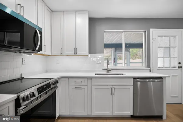 a kitchen with appliances cabinets and a sink