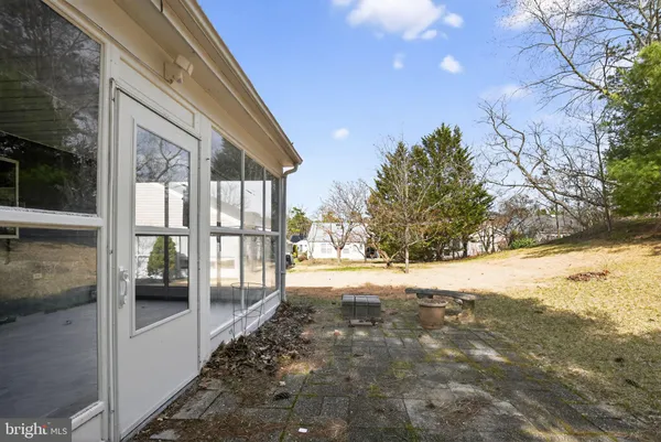 a view of a house with a yard and sitting area