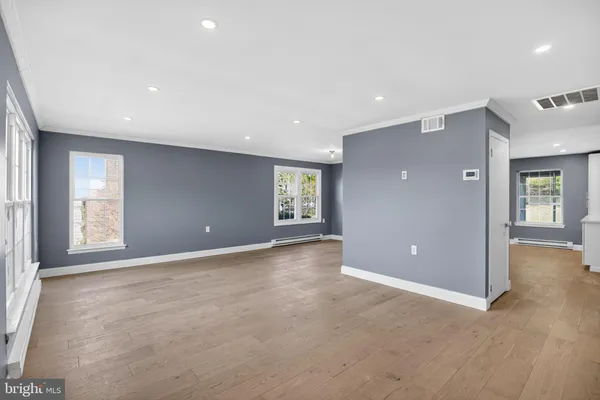 an empty room with windows and entrance