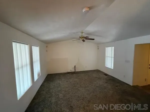 an empty room with a empty space and windows